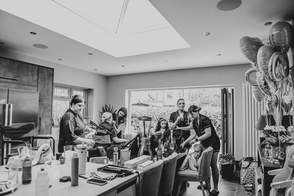 bridesmaids get ready in a kitchen