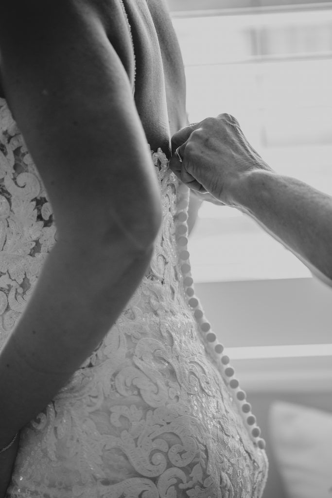 close up of button detail on wedding dress