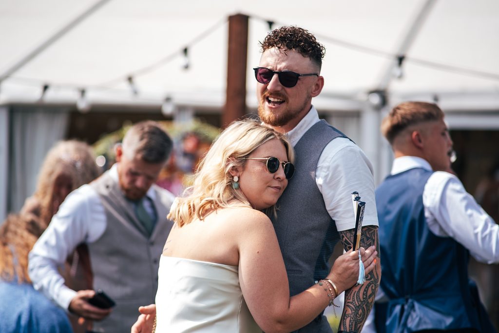 two guests hug at a wedding g