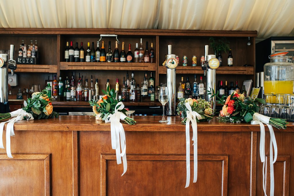 four bouquets rest on a bar