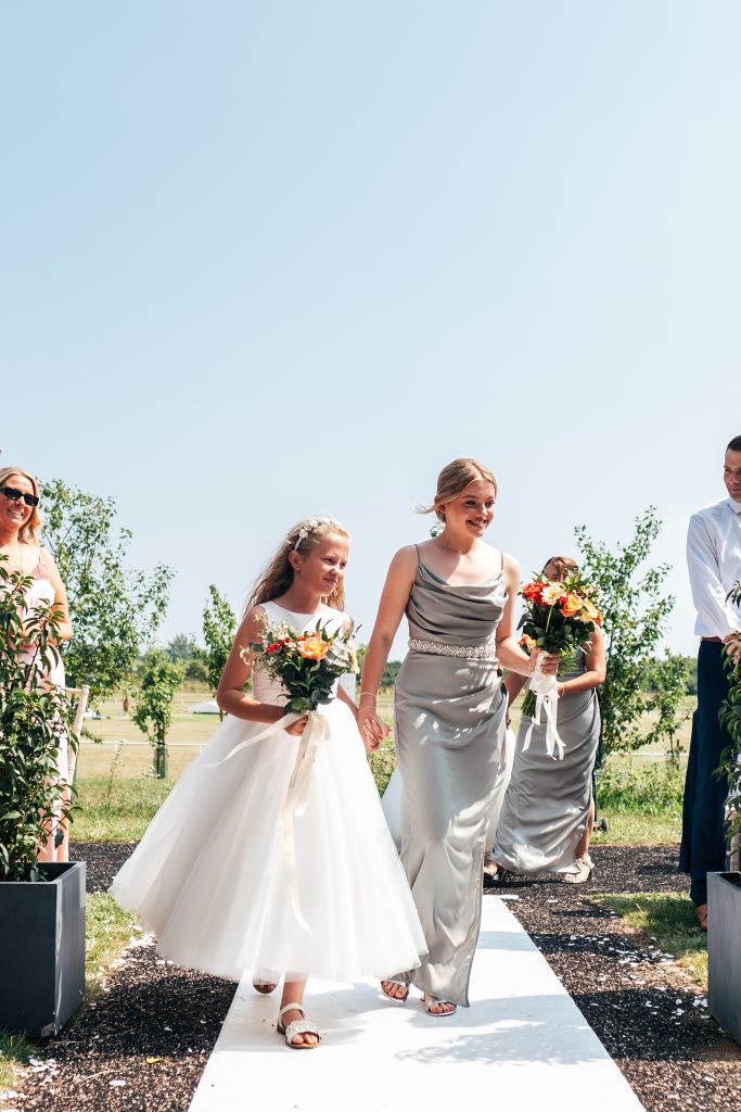 bridesmaids walk down aisle