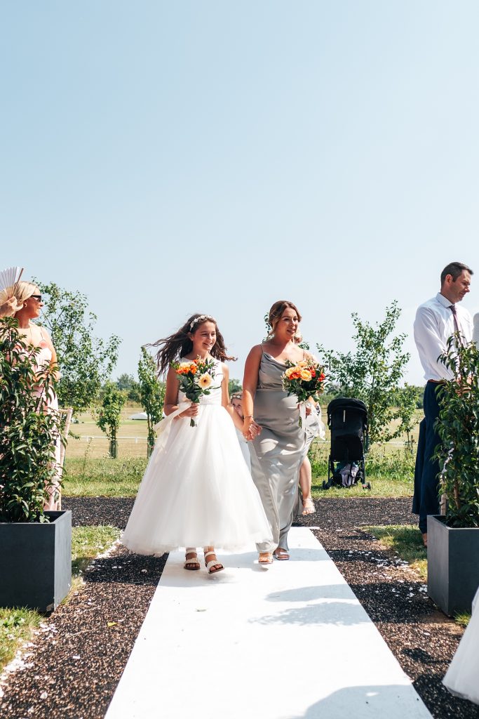 bridesmaids walk down aisle