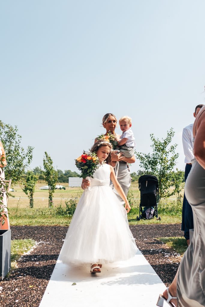 bridesmaids walk down aisle
