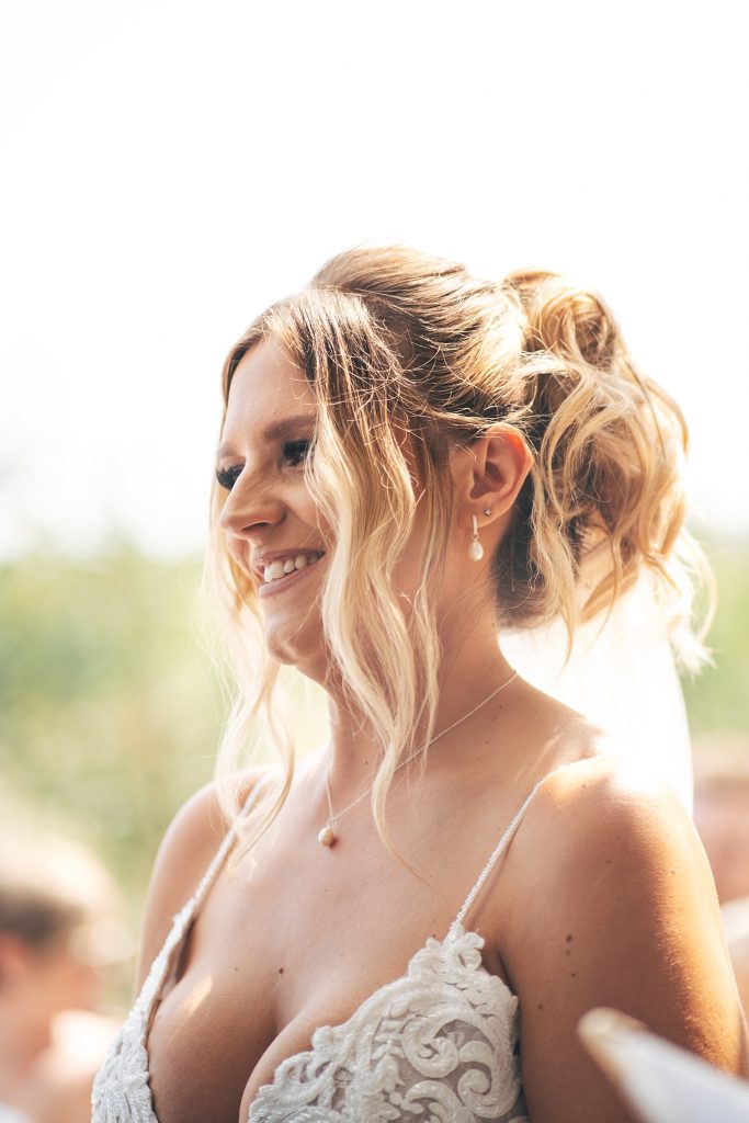 smiling bride at outdoor ceremony