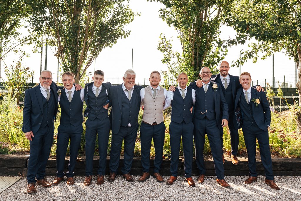 groom with groomsmen smile